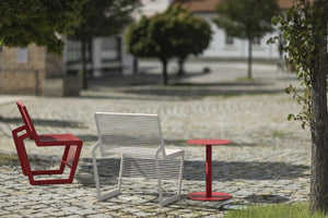 Arne Outdoor Chair in White Finish with Round Table in Outtdoor Setting