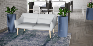 Koala Small Acoustic Planter in Blue Finish with Light Grey Sofa and White Top Bench Desk in Modern Office Setting