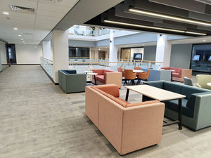 Lenny 2 Seater Low Back Chair in Different Finishes with White Top Tables in Modern Lounge Setting