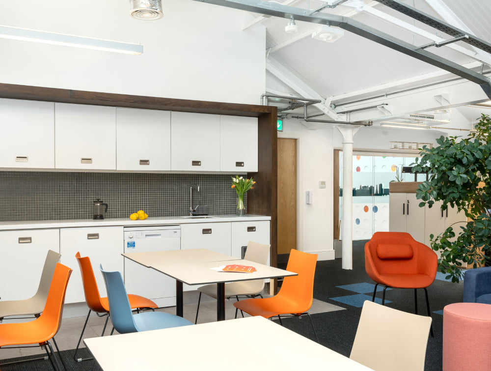 Square Top Table With Tub Chair And Indoor Plant In Canteen Setting