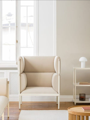 Stilt High Back Monochromatic Armchair with Coffee Table in Reception Setting