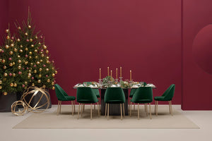 Aero Dining Table in Black Finish with Green Chair and Christmas Tree in Studio Setting