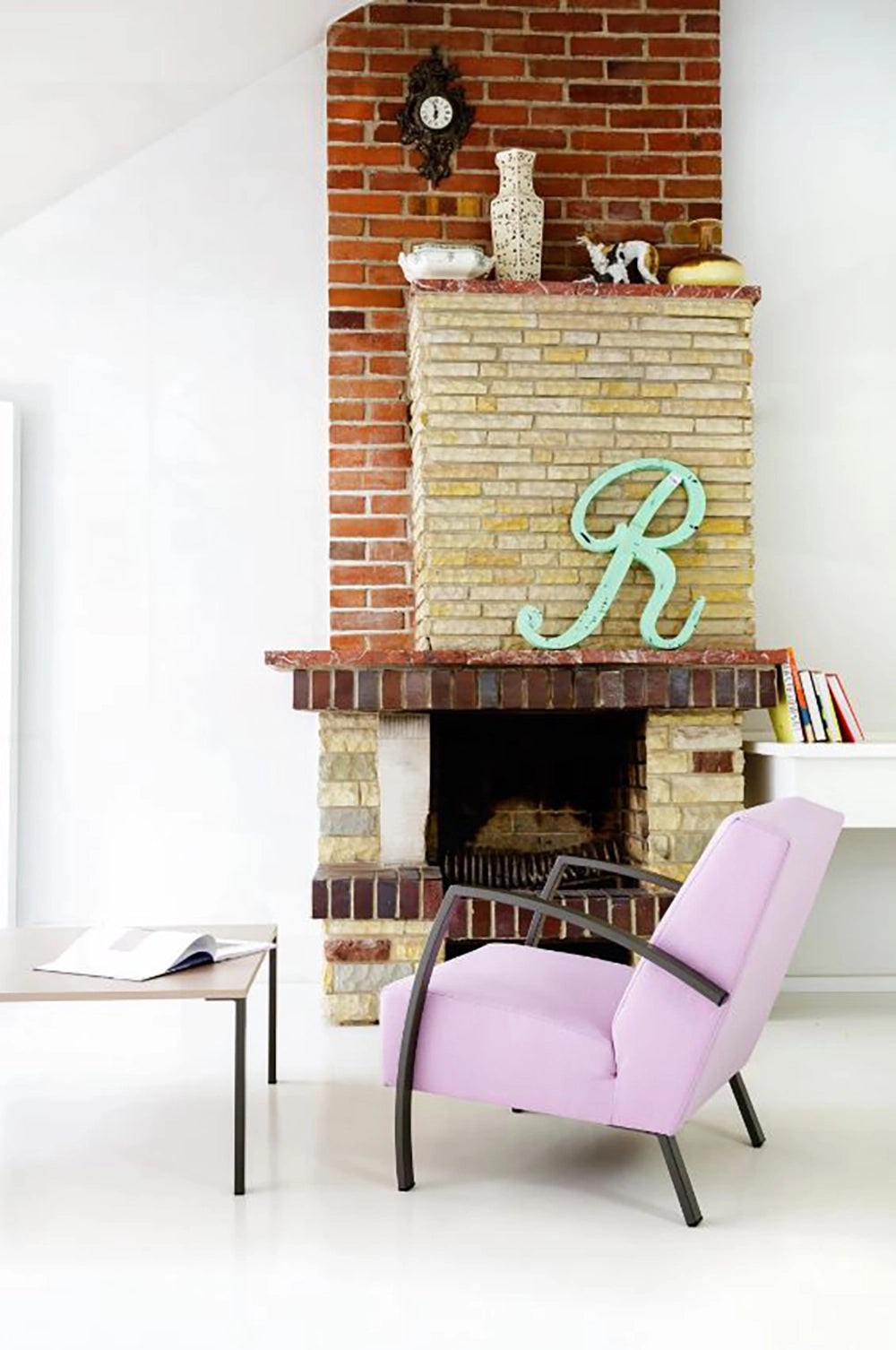 Age Armchair with Wooden Coffee Table and Antique Wall Clock in Living Room Setting