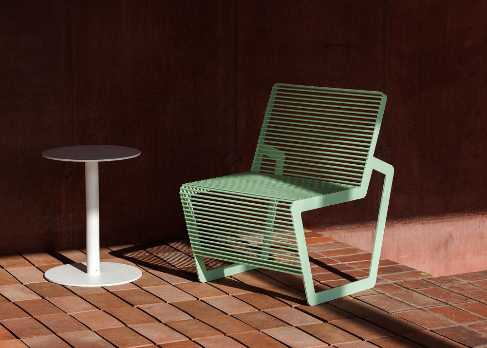 Arne Outdoor Chair with Round Side Table in Outdoor Setting 2