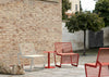 Arne Outdoor Chair with Round Side Table in Outdoor Setting