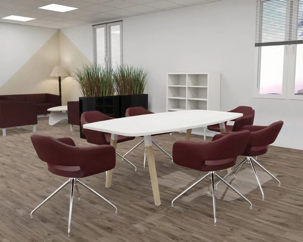 Buronomic Dialogue Barrel Meeting Table With Wooden Trapezium Legs In White Solid Wood Finish With Maroon Armchair And White Bookshelves In Meeting Room Setting