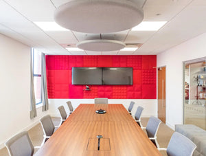 Buzzitile Wall Decor 2 In Red With Wood Top Table And Grey Chair In Conference Area