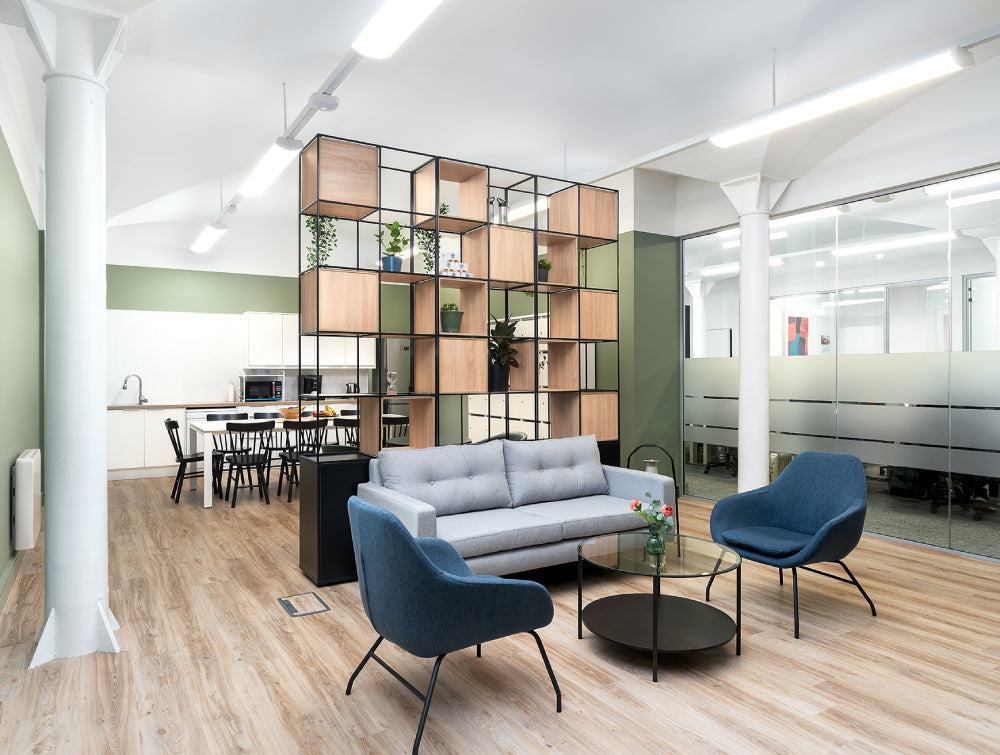 Grey Sofa With Round Coffee Table And Shelves In Breakout Setting