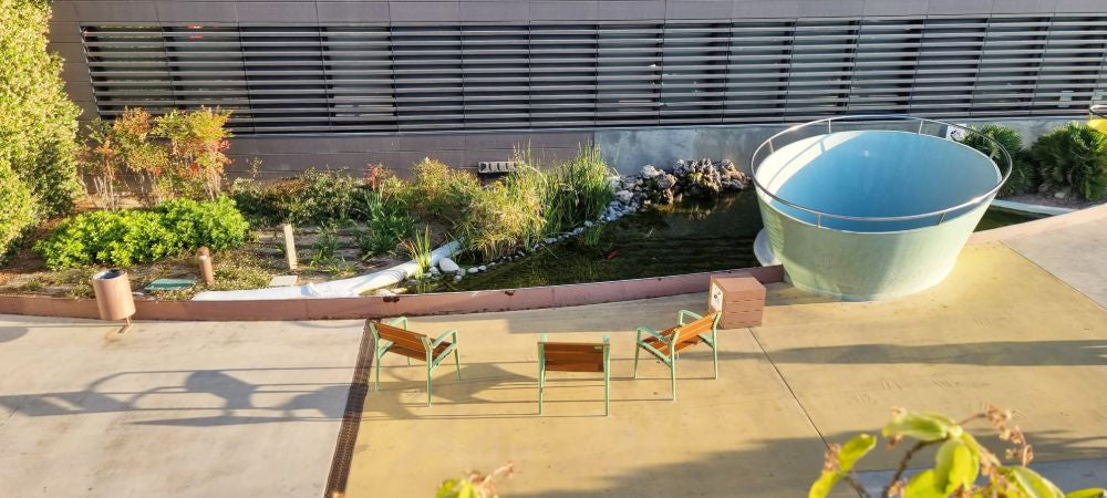 Minsk Wooden Outdoor Chair with Green Finish Armrests in Outdoor Setting 2