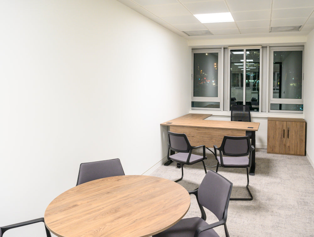 Round Wooden Table With Radil Desk And Meeting Room Chairsa In Breakout Setting