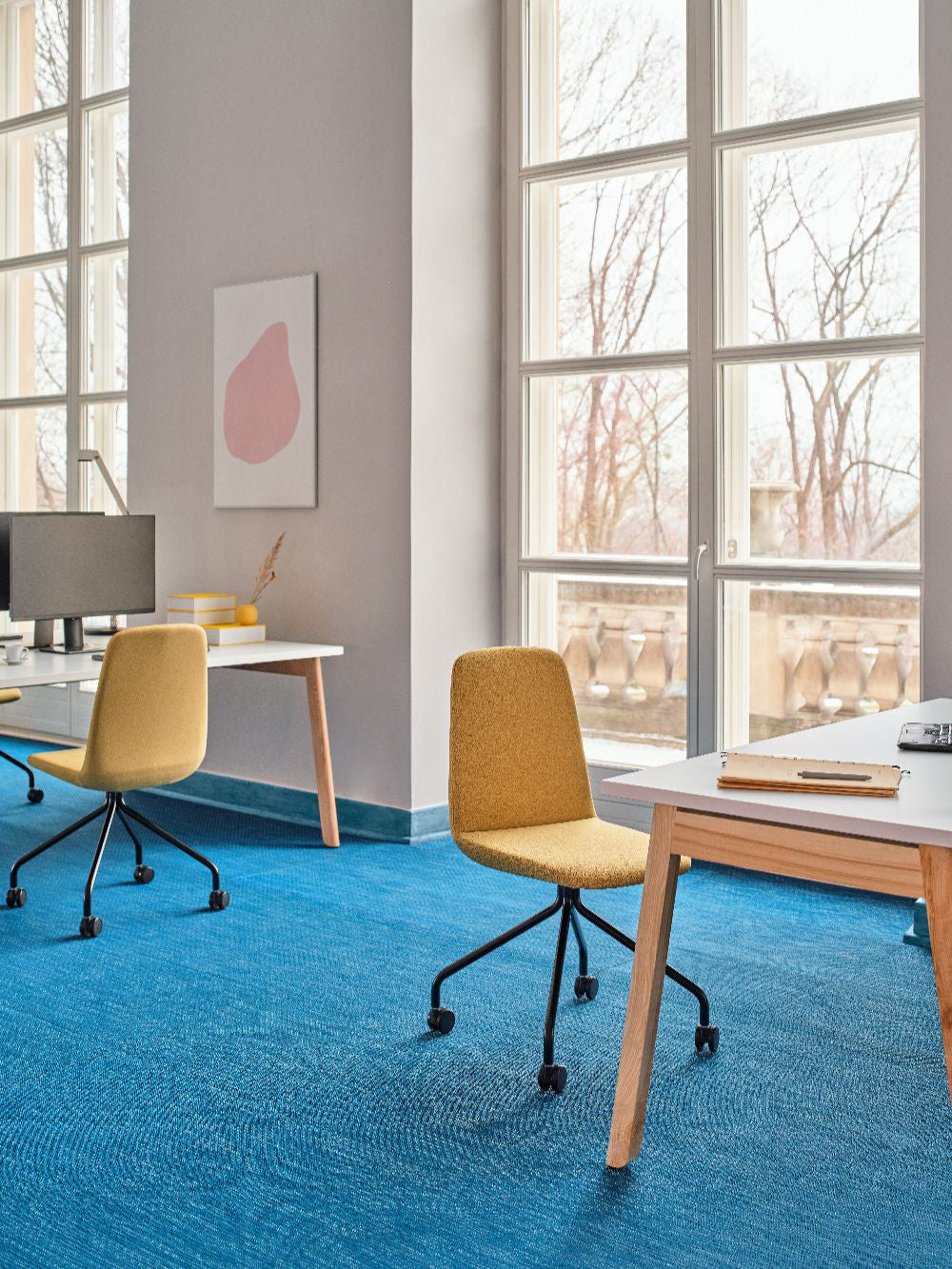 Ulti Office Chair on 4 Star Aluminium Base with Castors with Bench Desk and Computers in Modern Office Setting