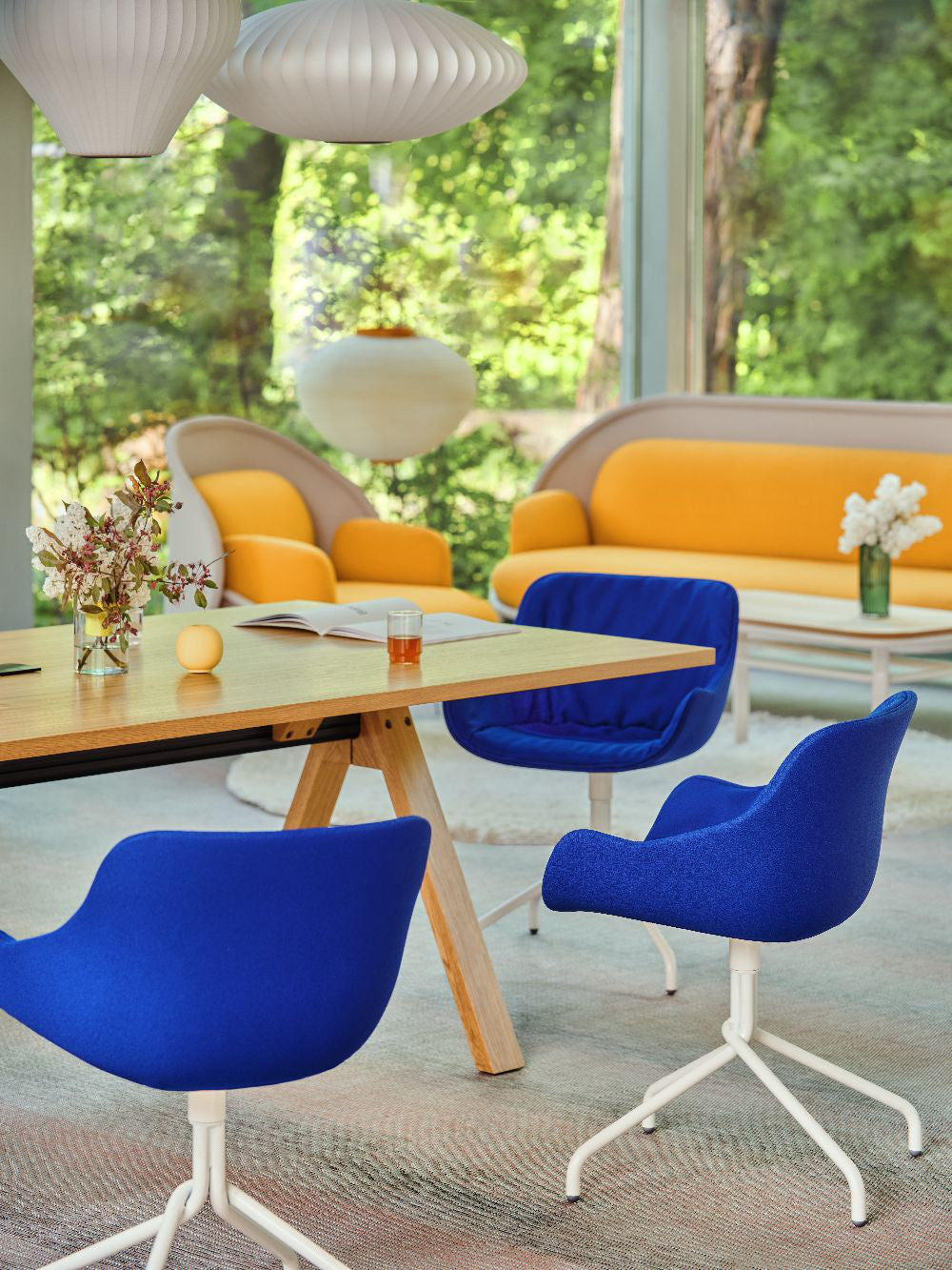 Ultra Office Chair with Wooden Table and Sofa in Modern Office Setting