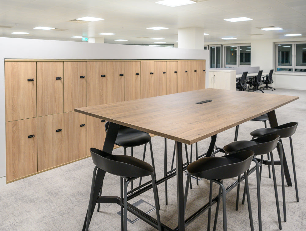 Wooden Lockers With Poseur Table And Barstool In Modern Office Setting